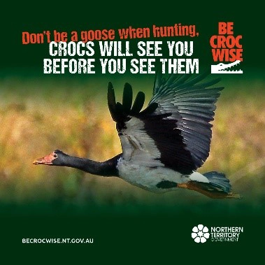 A flying magpie goose against a green background with text that reads: &ldquo;Don&rsquo;t be a goose when hunting. Crocs will see you before you see them.&rdquo; 